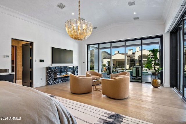 bedroom with a notable chandelier, access to exterior, lofted ceiling, crown molding, and light hardwood / wood-style flooring