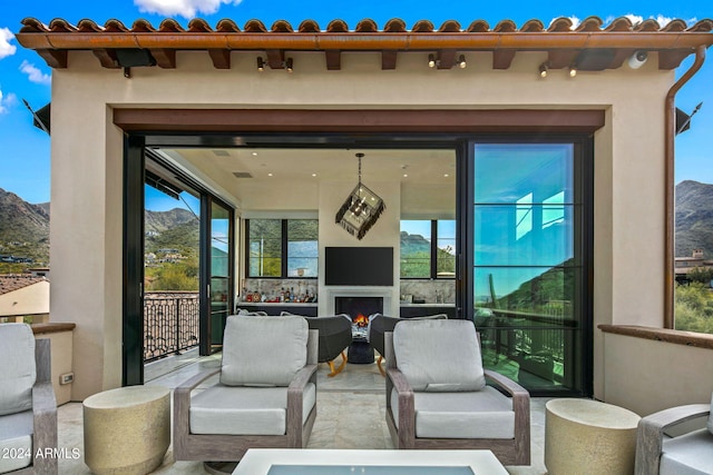 view of patio / terrace with a mountain view and an outdoor hangout area