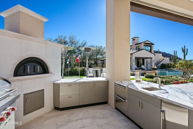 view of terrace with area for grilling, sink, and grilling area