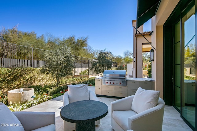 view of terrace featuring grilling area, an outdoor living space, and exterior kitchen