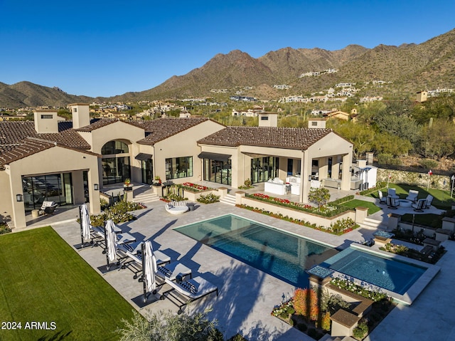 back of house featuring a mountain view, an outdoor hangout area, and a patio