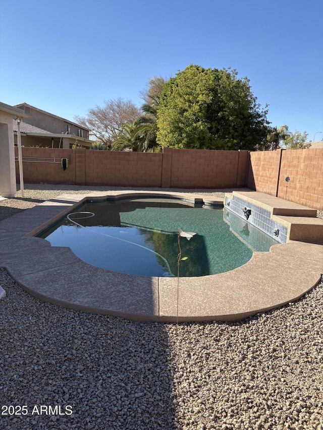 view of swimming pool with a fenced backyard and a fenced in pool