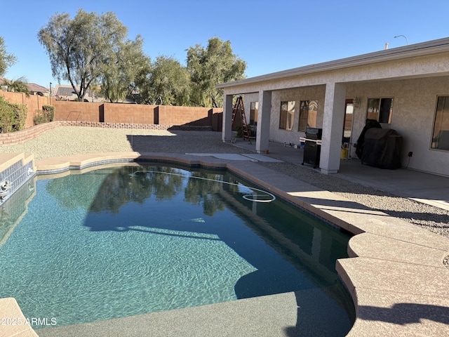 view of swimming pool with a fenced in pool, a grill, a patio, and a fenced backyard