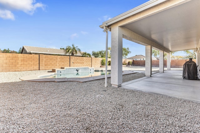 view of yard featuring a fenced in pool and a patio