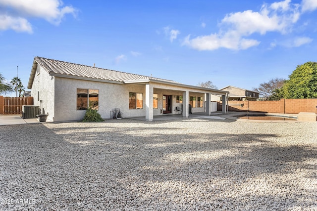 back of property featuring cooling unit and a patio area