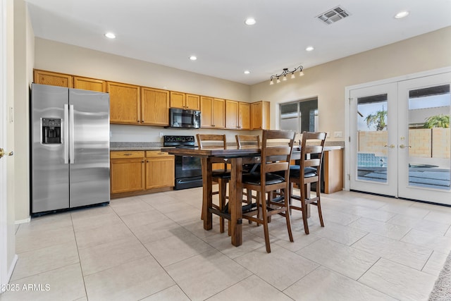 kitchen with french doors, light tile patterned floors, and black appliances