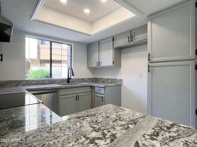 kitchen featuring dishwasher, ventilation hood, gray cabinets, and sink