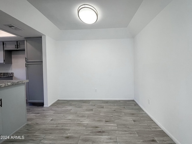 interior space featuring gray cabinets and light hardwood / wood-style flooring