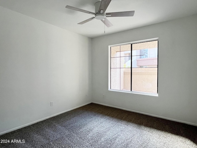 carpeted empty room featuring ceiling fan