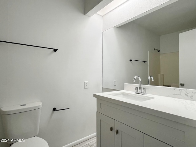 bathroom featuring hardwood / wood-style floors, vanity, and toilet