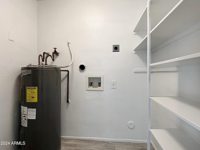 washroom featuring washer hookup, electric dryer hookup, electric water heater, and light hardwood / wood-style flooring