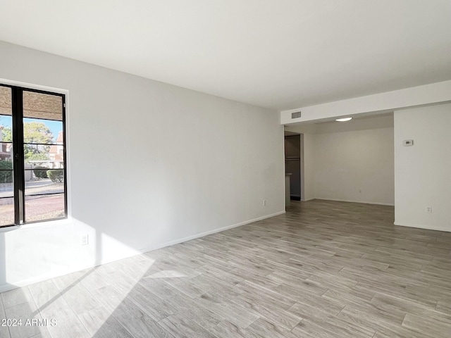 spare room with light hardwood / wood-style floors