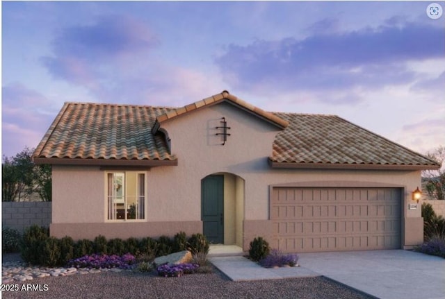 mediterranean / spanish-style home with a garage