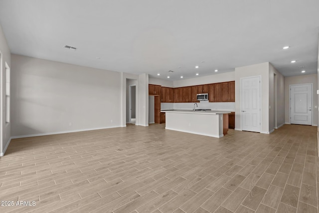 12311 W Parkway Ln, Avondale, AZ 85323 - unfurnished living room featuring recessed lighting, baseboards, a sink, and light wood-type flooring