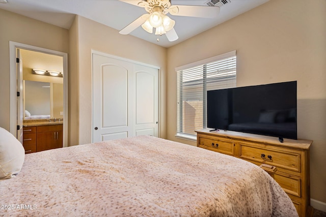 bedroom with ensuite bath, ceiling fan, and a closet