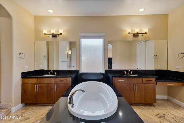 bathroom featuring a bathing tub and vanity