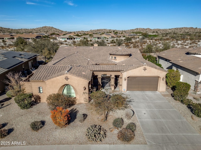 view of front facade featuring a mountain view and a garage