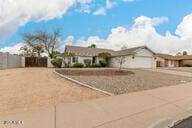 ranch-style home with driveway and a garage