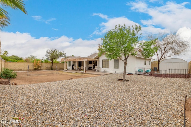 back of house with a patio area, stucco siding, and a fenced backyard