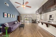 interior space with vaulted ceiling, ceiling fan, and wood finished floors