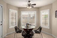 dining area with baseboards and ceiling fan