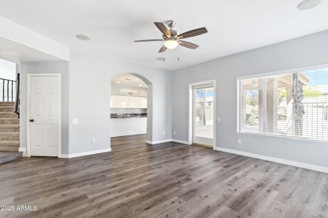 3641 E Park Ave, Phoenix, AZ 85044 - unfurnished living room featuring a ceiling fan, wood finished floors, stairway, and baseboards