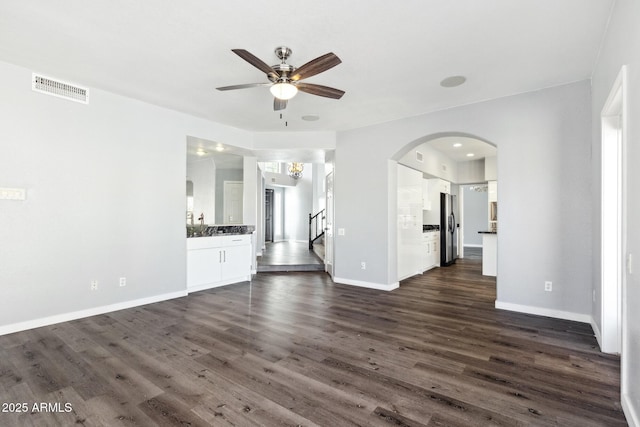 3641 E Park Ave, Phoenix, AZ 85044 - unfurnished living room featuring a ceiling fan, dark wood-type flooring, stairs, and baseboards
