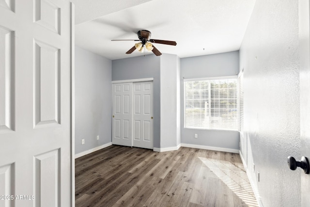 3641 E Park Ave, Phoenix, AZ 85044 - unfurnished bedroom with wood finished floors, baseboards, ceiling fan, and a closet