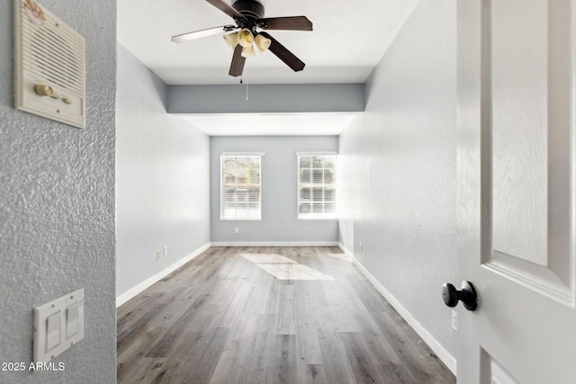 3641 E Park Ave, Phoenix, AZ 85044 - spare room featuring wood finished floors, ceiling fan, baseboards, and a textured wall