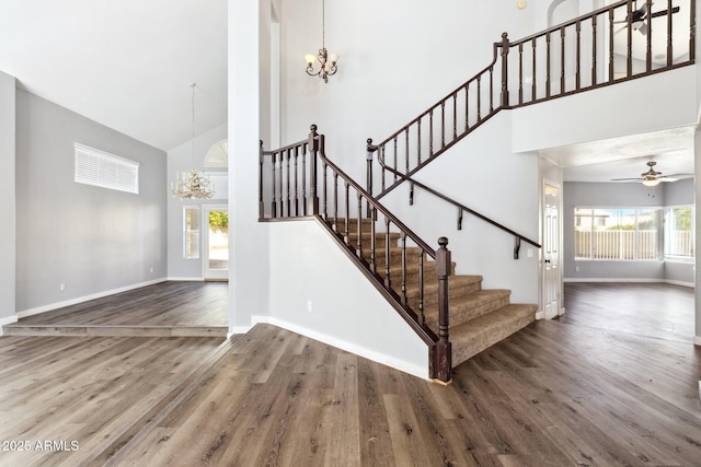 3641 E Park Ave, Phoenix, AZ 85044 - stairs with a chandelier, high vaulted ceiling, wood finished floors, and baseboards