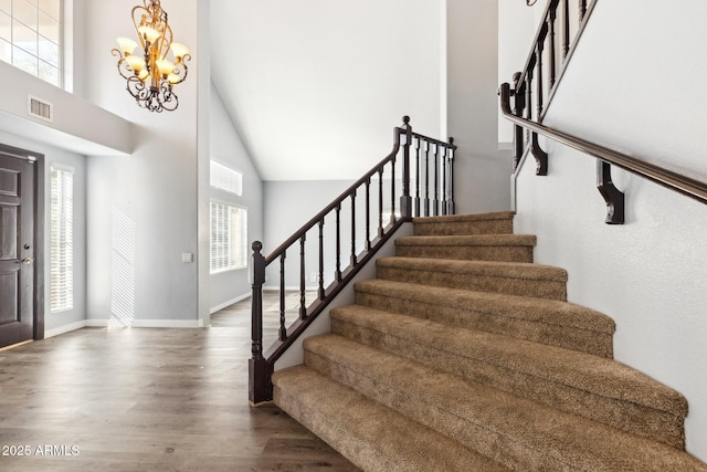3641 E Park Ave, Phoenix, AZ 85044 - foyer entrance with stairs, wood finished floors, high vaulted ceiling, a chandelier, and baseboards