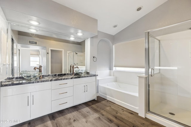 3641 E Park Ave, Phoenix, AZ 85044 - bathroom with a bath, double vanity, vaulted ceiling, a shower stall, and wood finished floors
