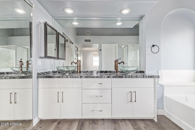 3641 E Park Ave, Phoenix, AZ 85044 - bathroom with a stall shower, wood finished floors, double vanity, and a garden tub