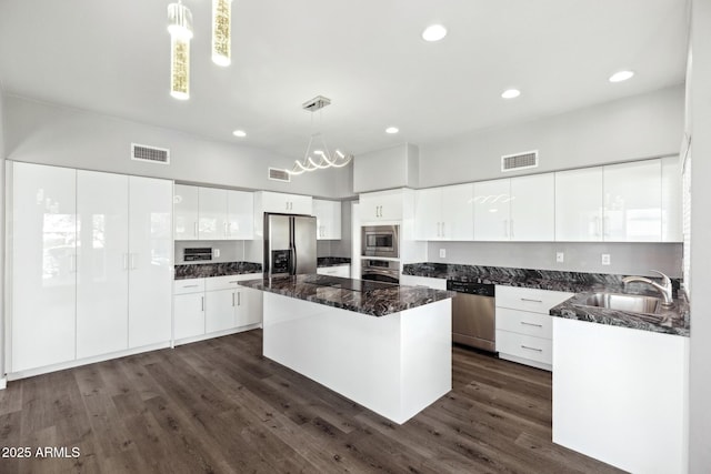 3641 E Park Ave, Phoenix, AZ 85044 - kitchen featuring stainless steel appliances, a sink, a center island, white cabinetry, and recessed lighting