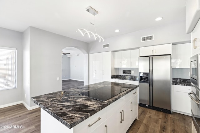 3641 E Park Ave, Phoenix, AZ 85044 - kitchen with appliances with stainless steel finishes, dark wood-style floors, arched walkways, white cabinets, and pendant lighting
