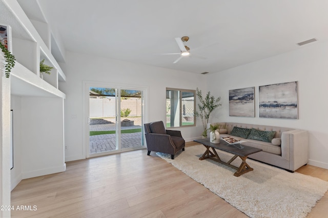 living room featuring ceiling fan and light wood-type flooring