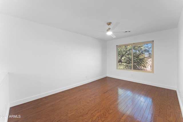 unfurnished room featuring ceiling fan and dark hardwood / wood-style flooring