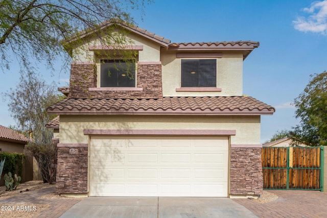 mediterranean / spanish-style home with a garage