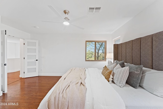 bedroom with hardwood / wood-style flooring and ceiling fan