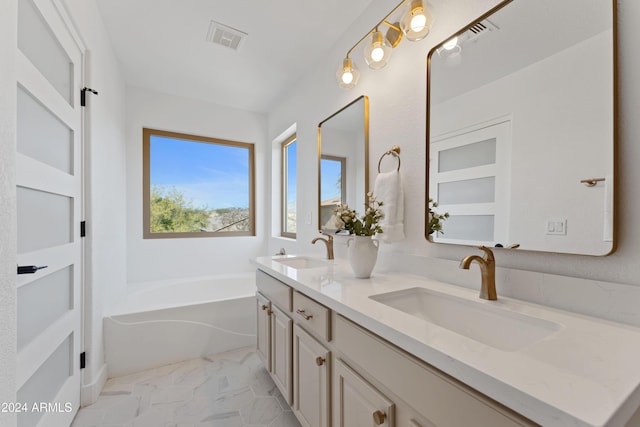 bathroom featuring a washtub and vanity