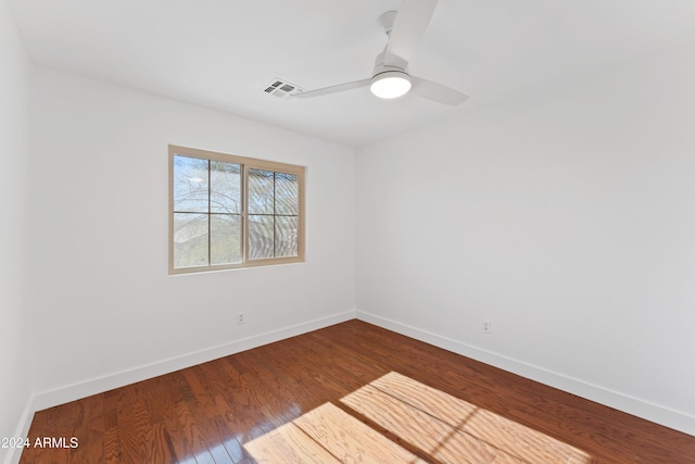 spare room with ceiling fan and wood-type flooring