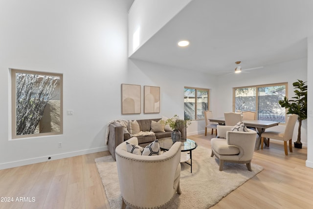 living room featuring light wood-type flooring and ceiling fan