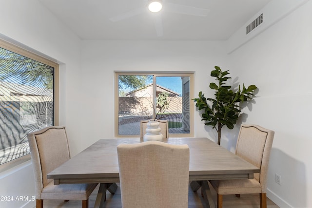 dining area with hardwood / wood-style floors and ceiling fan