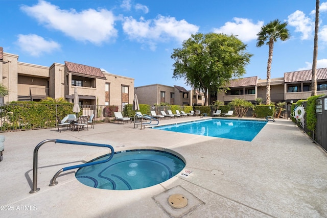 view of swimming pool with a community hot tub and a patio area