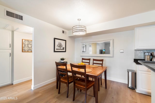 dining space featuring light wood-type flooring