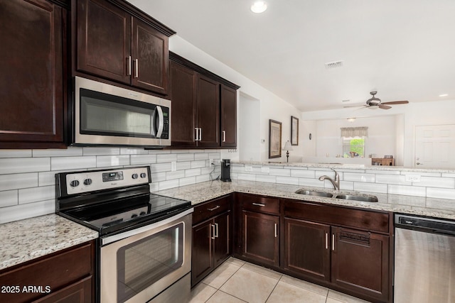 22403 W Harrison St, Buckeye, AZ 85326 - kitchen with stainless steel appliances, backsplash, light stone countertops, and recessed lighting