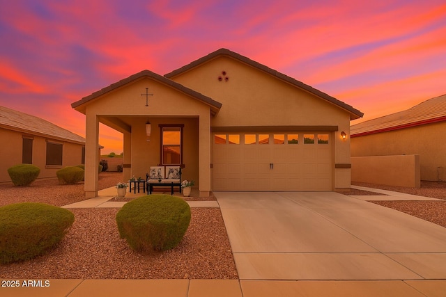 22403 W Harrison St, Buckeye, AZ 85326 - view of front of home featuring stucco siding, an attached garage, and concrete driveway