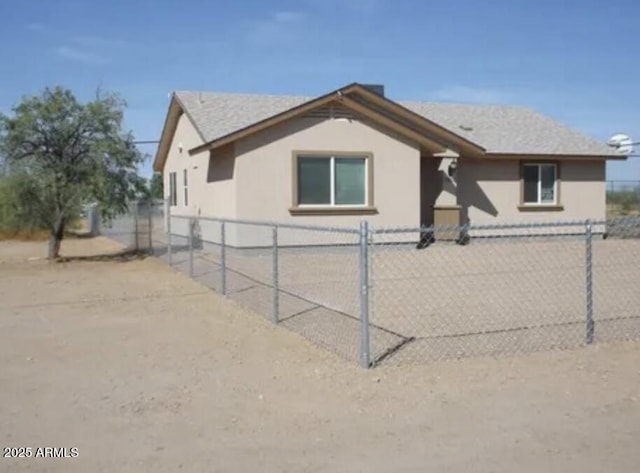 view of home's exterior featuring driveway, a fenced front yard, and stucco siding