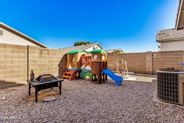 view of play area featuring a fire pit and central AC unit