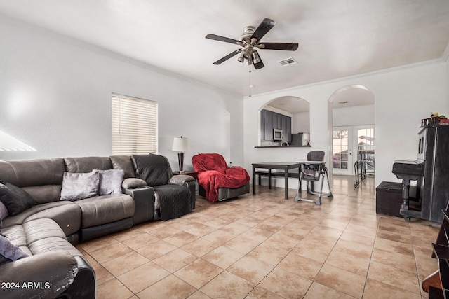 living room featuring crown molding, ceiling fan, and light tile patterned flooring